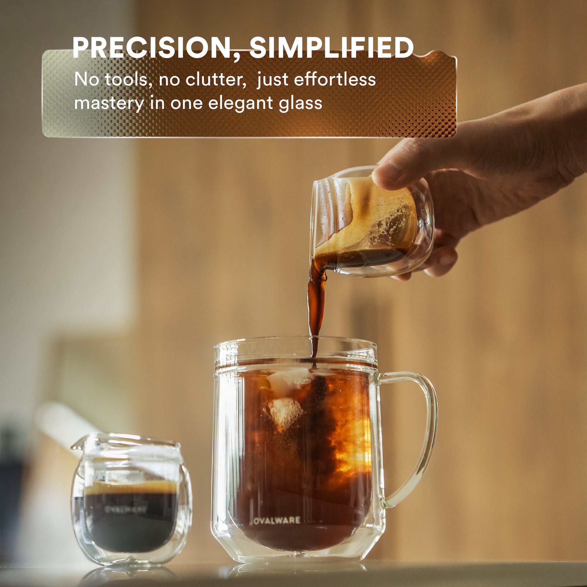 Hand pouring coffee into a glass mug with a coffee bag, text 'PRECISION, SIMPLIFIED' above.